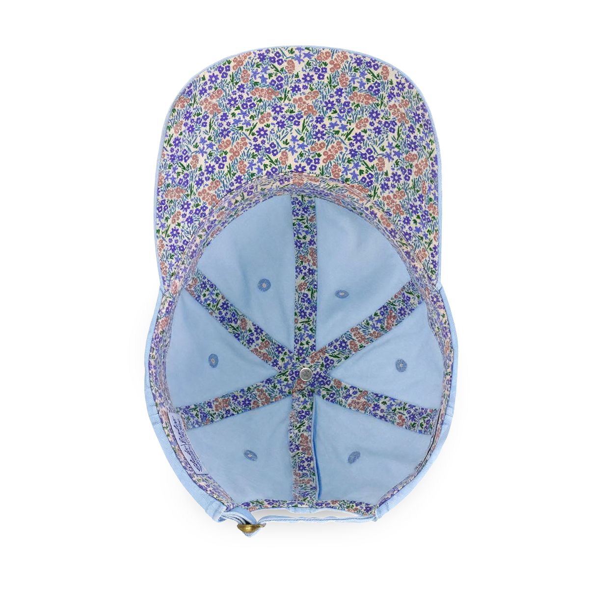 Inside of the cashmere blue cap showing the floral print lining and adjustable buckle