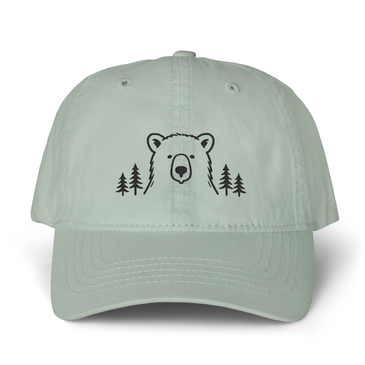 Sage green cotton dad hat with a minimalist black embroidered bear between pine trees